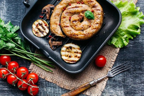 Grill pan with delicious spiral grilled sausage vegetable