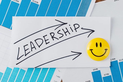 Top view smiley face with word leadership