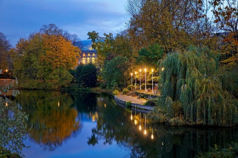 The Staendehaus K21 is reflected in the Kaiserteich in autumn in the evening