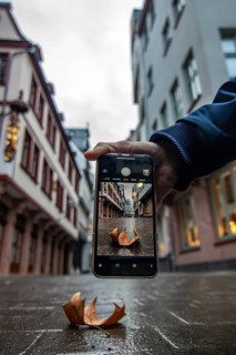 Reflection in a puddle between a historic city centre. Cityscape at the Roemer and the historic houses and streets. Cityscape in Frankfurt am Main