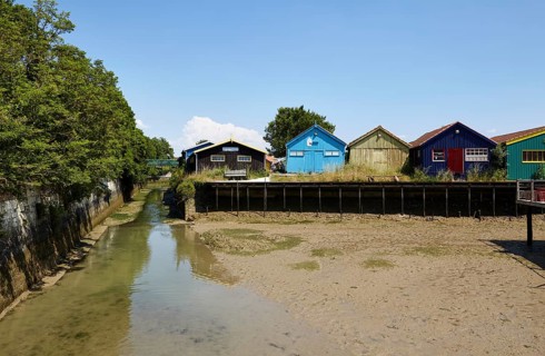 Colourful houses at low tide in Le Chateau-d'Oleron