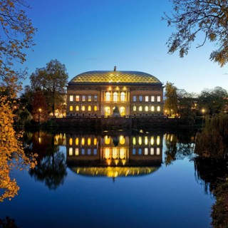 The Staendehaus K21 is reflected in the Kaiserteich in autumn in the evening