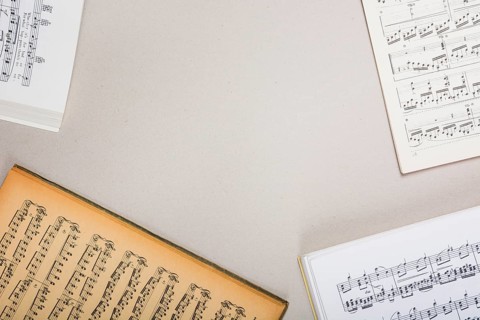 Overhead view musical note books white background with space text