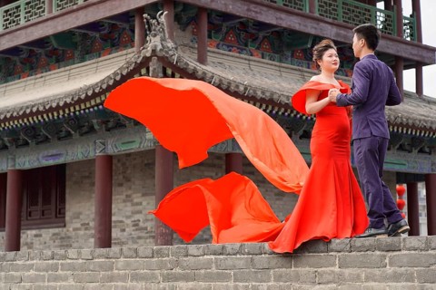 Wedding couple standing on the city wall in Xian
