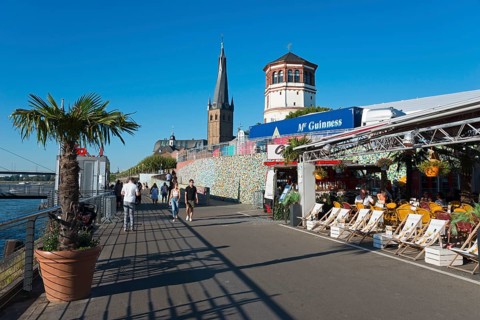 Rhine promenade with St Lambert's Basilica and castle tower