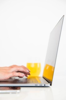 Top view laptop with orange juice