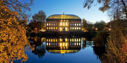 The Staendehaus K21 is reflected in the Kaiserteich in autumn in the evening