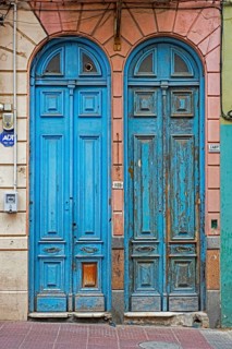 Two blue narrow front doors of colonial houses in the Ciudad Vieja