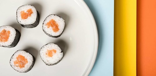 Minimalist plate with sushi rolls close up