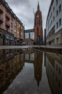 Reflection in a puddle between a historic city centre. Cityscape at the Roemer and the historic houses and streets. Cityscape in Frankfurt am Main