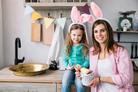 Young woman daughter standing with basket easter eggs