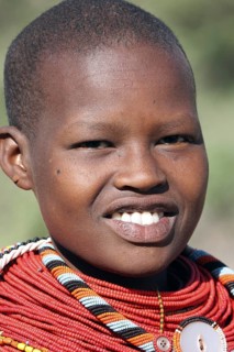 Portrait of young Turkana woman in traditional red clothing in northwest Kenya
