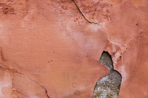 Paint peeling off concrete wall surface