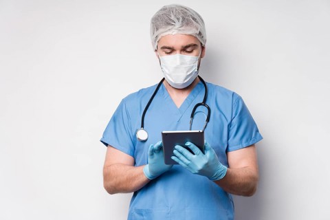 Portrait nurse browsing tablet