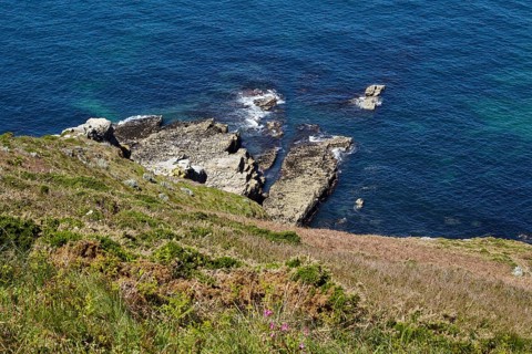 Cliff with rocks in the Atlantic Ocean near Cap Frehel in Plevenon
