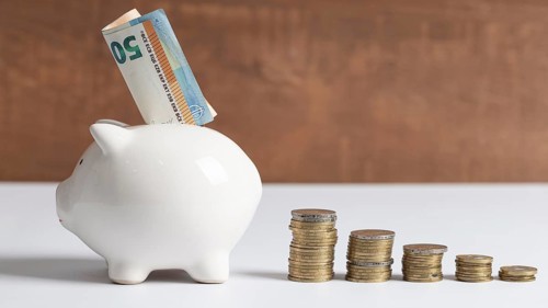 Side view piggy bank with coins banknotes