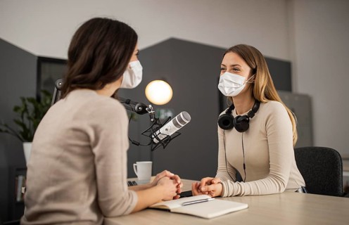 Smiley women doing radio with medical masks