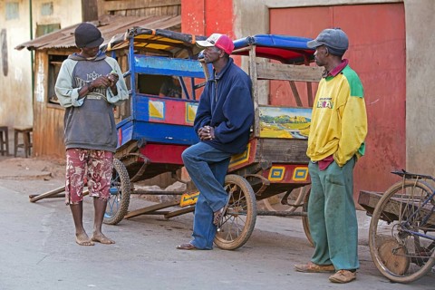 Three pousse-pousse drivers waiting for customers in the streets of the city Ambalavao