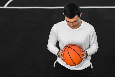 Portrait man holding basketball