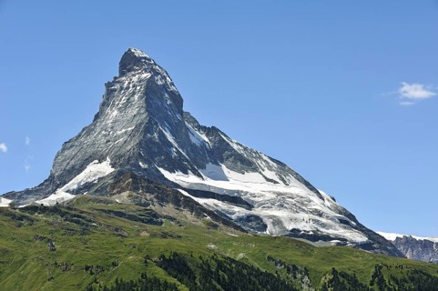 View over the Matterhorn mountain with alpine meadows and pine forests near Zermatt
