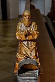 Praying figure on a church bench