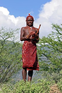 Portrait of young Turkana warrior in traditional red clothing in northwest Kenya