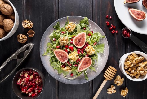 Top view plate with autumn fig salad walnuts