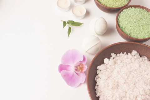 White green spa bath salt bowl with spa bomb orchid white backdrop