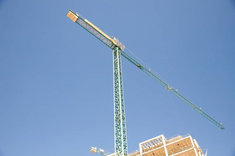 Low angle view construction site against blue sky