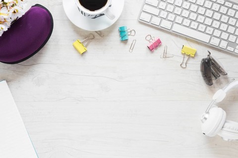Office supplies coffee cup headphone keyboard white desk