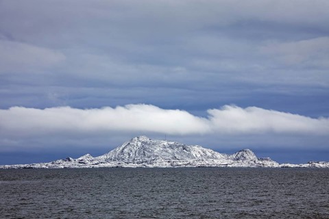 View over the Gimsoystraumen fjord and mountains in the snow in winter