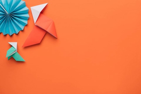 Origami paper craft art dark orange surface