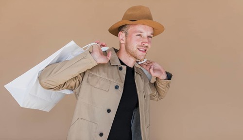 Smiley man with brown hat shopping bags