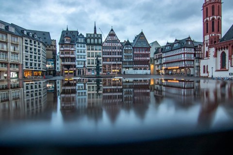 Reflection in a puddle between a historic city centre. Cityscape at the Roemer and the historic houses and streets. Cityscape in Frankfurt am Main