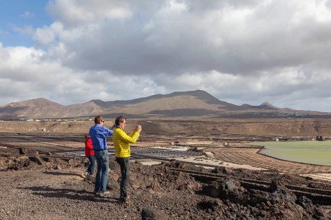 Tourists photographing the Janubio salt flats