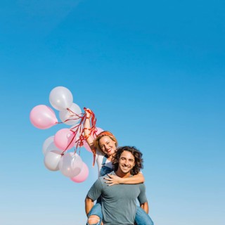 Woman with balloons back man
