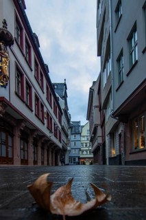 Reflection in a puddle between a historic city centre. Cityscape at the Roemer and the historic houses and streets. Cityscape in Frankfurt am Main