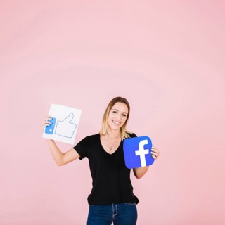 Portrait happy woman with facebook thumbs up icon