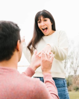 Young man proposing excited girlfriend