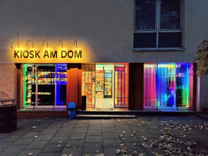 Brightly coloured illuminated kiosk at the cathedral
