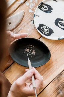 Woman doing pottery masterpiece her workshop