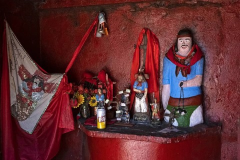 Traditional red roadside shrine to folk saint Gauchito Gil