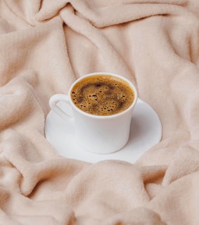 High angle morning cup coffee bed