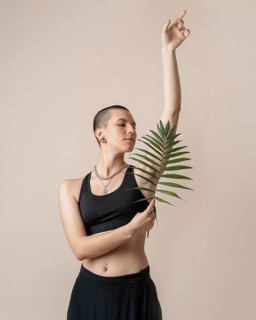 Medium shot woman posing with plant