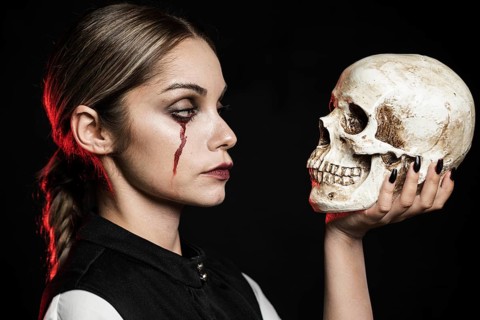 Side view woman holding skull