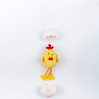 Toy small chicken with egg shell white table