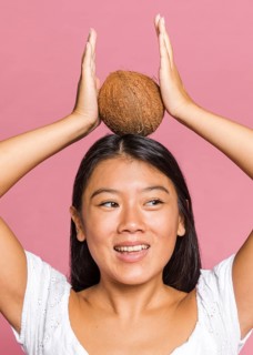 Woman holding coconut her head