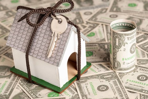 Wrapped house with keys money background