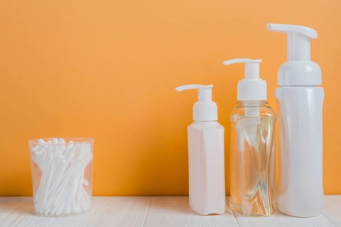 White ear buds with soap dispenser bottles white table