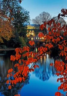 The Staendehaus K21 is reflected in the Kaiserteich in autumn in the evening